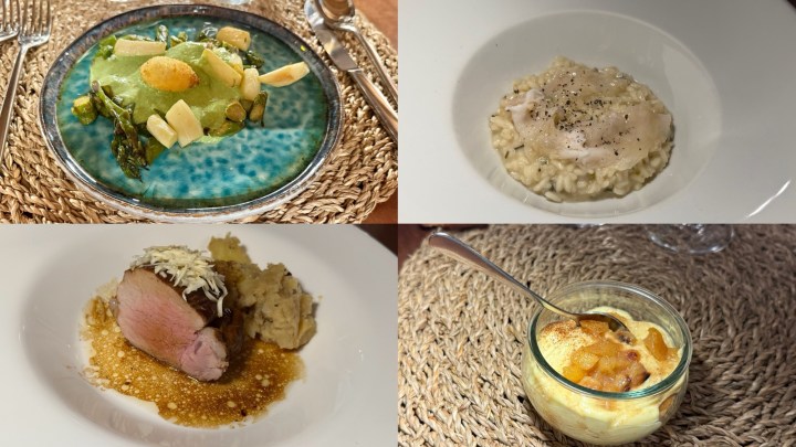 A beautifully presented dish featuring green asparagus and local greens on a decorative blue plate.