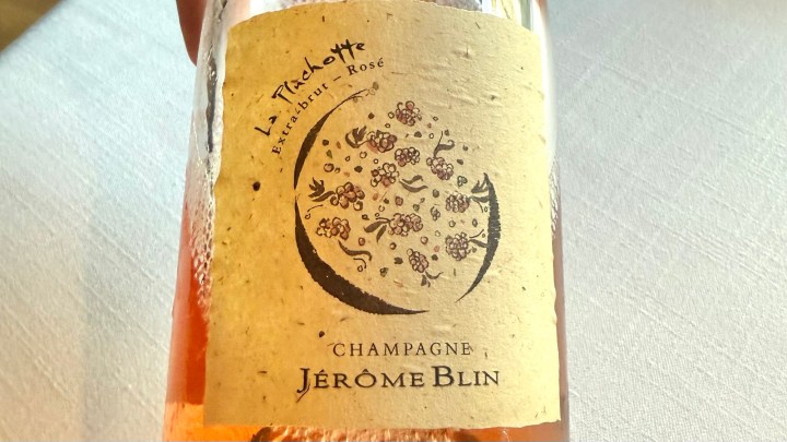Bottle of La Pluchotte Extra Brut Rosé Champagne by Jérôme Blin, featuring intricate floral designs on the label.