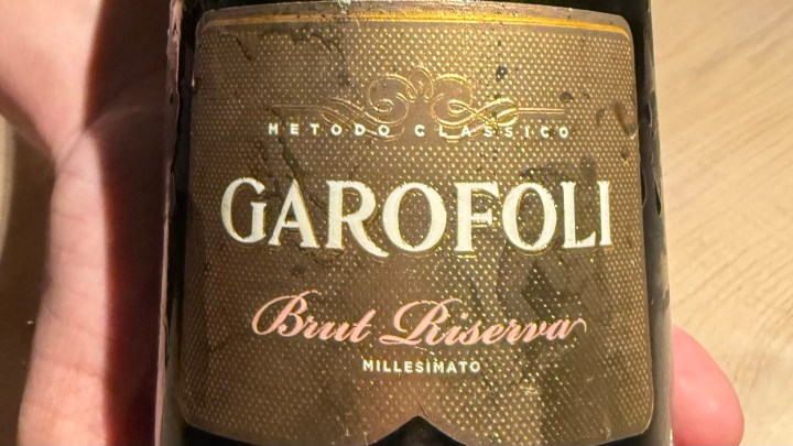 Close-up of a Garofoli Brut Riserva wine bottle with a textured label.