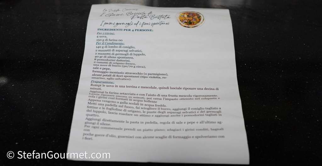 Italian recipe handwritten on paper for a dish featuring girini pasta with rabbit and seasonal ingredients.