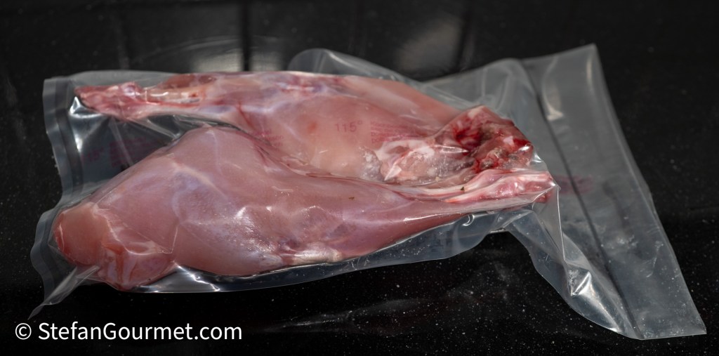Two rabbit legs vacuum sealed in a bag, ready for sous vide cooking.