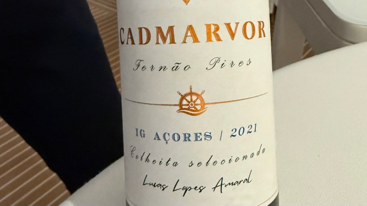A close-up of a wine bottle labeled "Cadmarvor Fernão Pires 2021" from the Azores, featuring nautical-themed design elements.