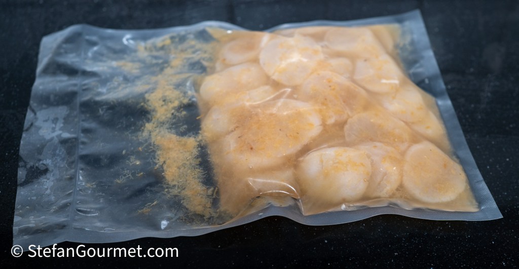 Vacuum-sealed bag containing marinated scallops in a clear liquid mixture.