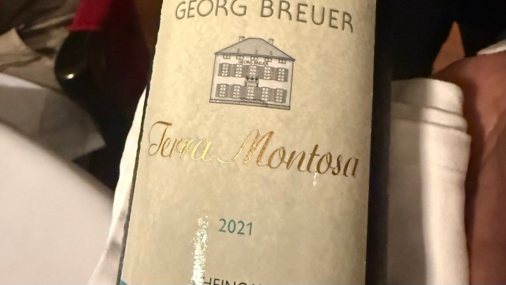 A close-up image of a wine bottle labeled 'Georg Breuer Terra Montosa 2021', showcasing a detailed design with a house illustration and elegant typography.