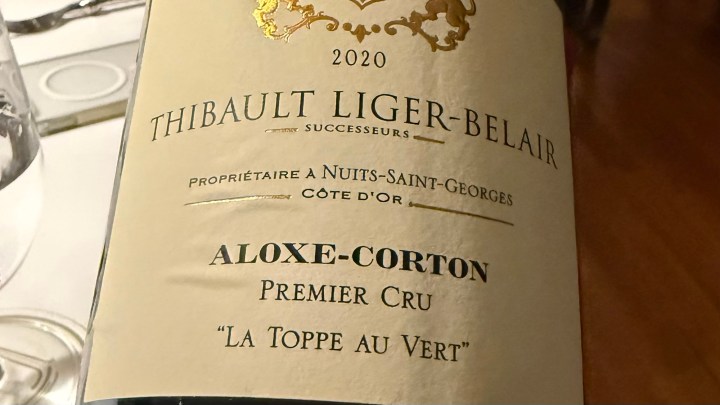 Close-up of a wine bottle label showing '2020 Thibault Liger-Belair, Aloxe-Corton Premier Cru, La Toppe au Vert'.