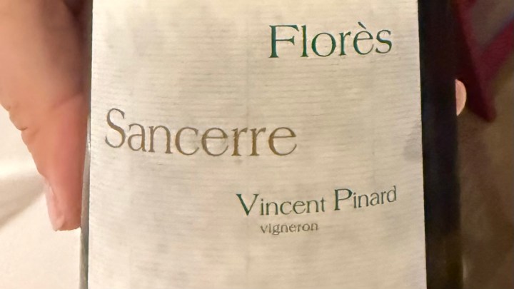Close-up of a wine bottle label for Florès Sancerre by Vincent Pinard, featuring elegant typography.