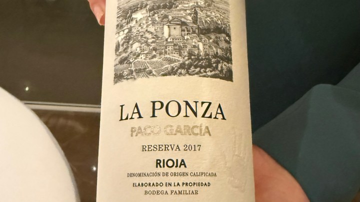 Close-up of a wine bottle label featuring 'La Ponza' by Paco Garcia, Reserva 2017, from the Rioja region, with a black and white illustration of a vineyard landscape.