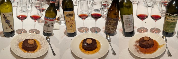 A table setting featuring four chocolate desserts on white plates, each topped with a circular cookie, surrounded by various bottles of Barolo wine and glasses filled with red wine.
