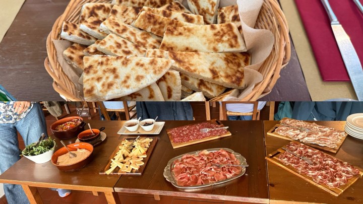 A basket of freshly baked bread with a golden-brown crust on a wooden table.