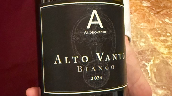 A close-up of a wine bottle label featuring 'Alto Vanto Bianco 2024' by Aldrovandi.