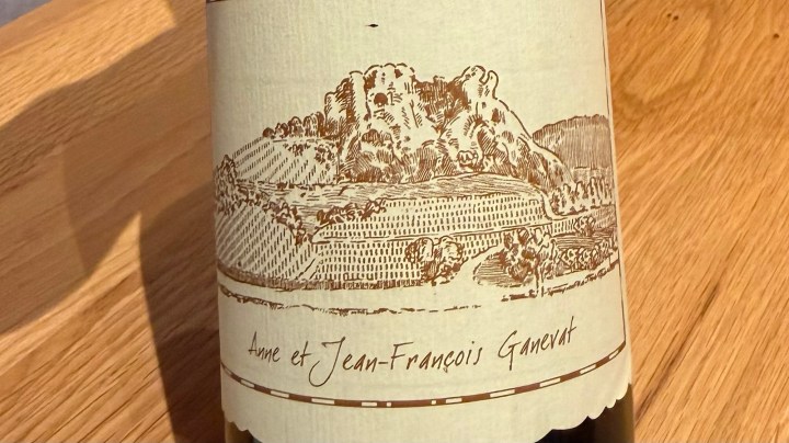 Close-up of a wine bottle label featuring an illustration of a vineyard landscape and the names 'Anne et Jean-François Ganevat'.
