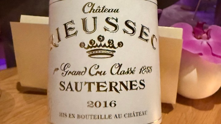 Close-up of a bottle label from Château Rieussec, a Sauternes wine, vintage 2016, featuring the text '1er Grand Cru Classé 1855' and a decorative crown.