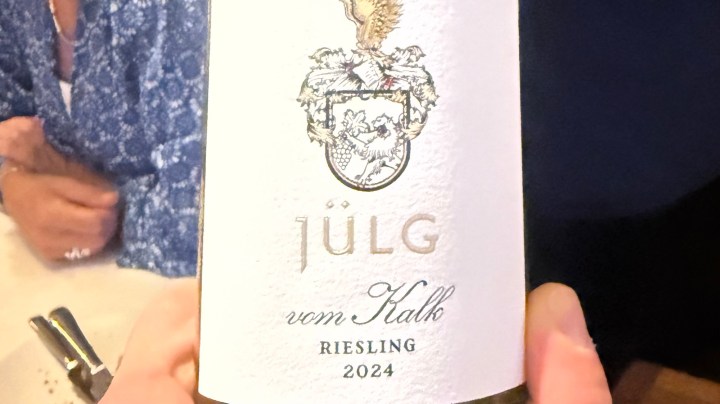 Close-up of a wine bottle label featuring 'Jülg vom Kalk Riesling 2024' with a detailed coat of arms design.