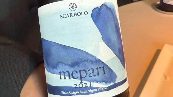 Close-up of a wine bottle label featuring Scarbolo Mepari 2021 Pinot Grigio, with a blue watercolor design.